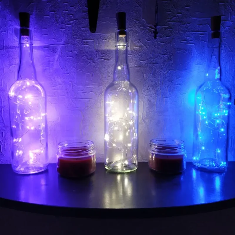 Glass bottles illuminated with party glow supplies and vibrant LED string lights.