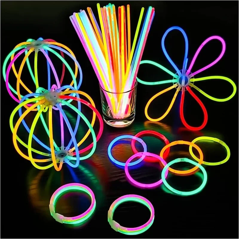 Assorted neon glow stick necklaces arranged in creative shapes with glowing accessories.